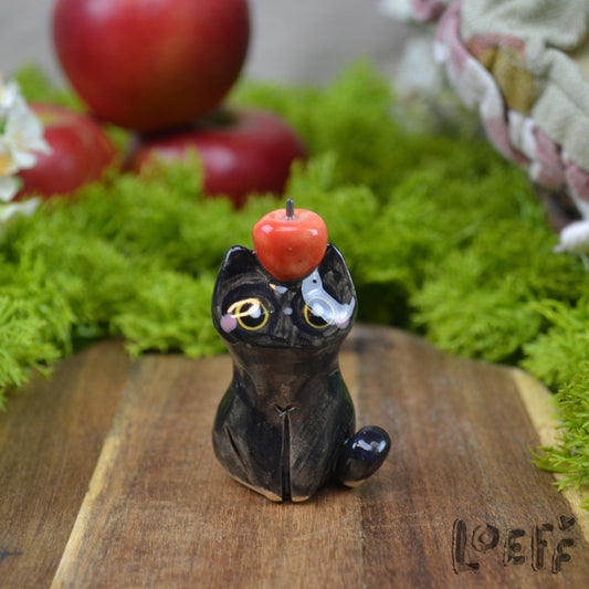 Tiny Black Cat with Apple