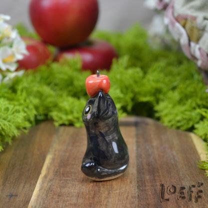 Tiny Black Cat with Apple