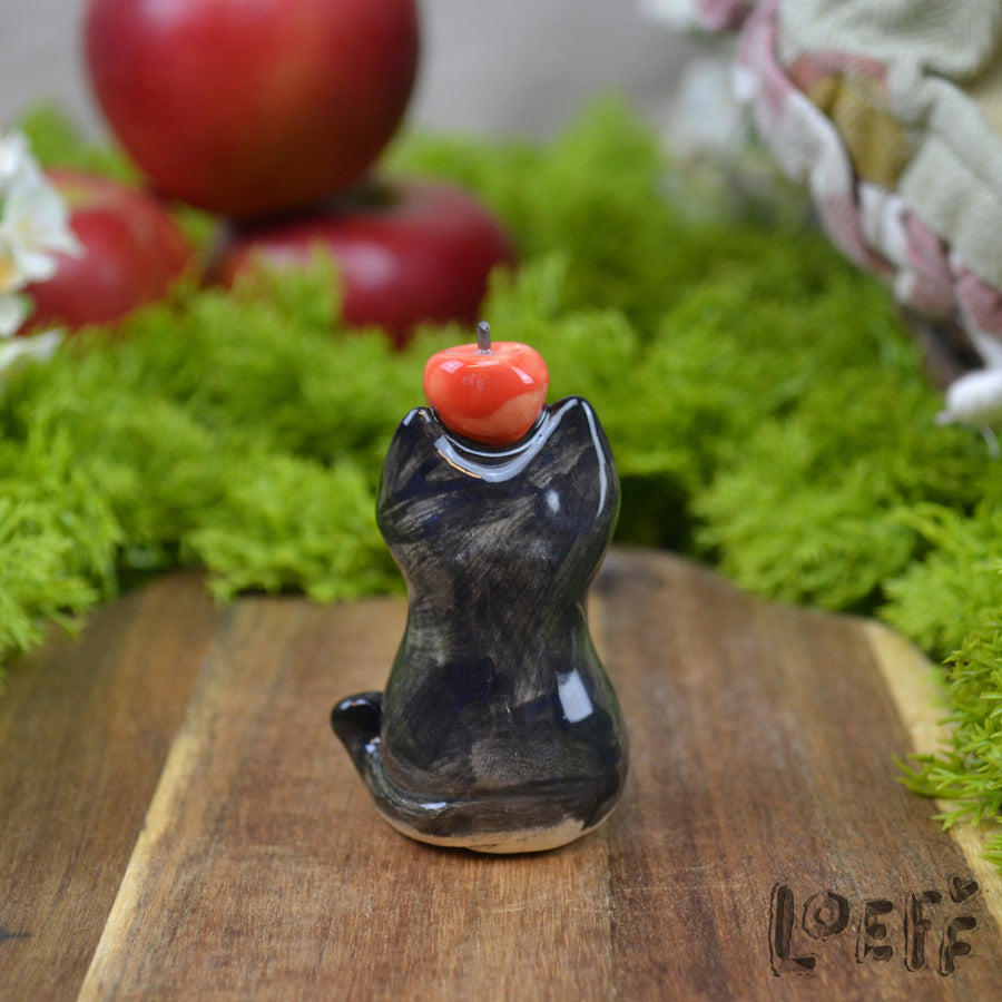Tiny Black Cat with Apple