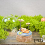 Showstopper Loeff Small Dome Otter Swimming Between Flowers